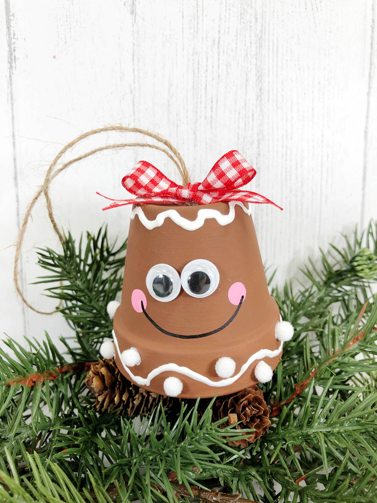 A gingerbread ornament with a smiley face on it.