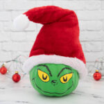 Grinch pumpkin with lights and ornaments in background