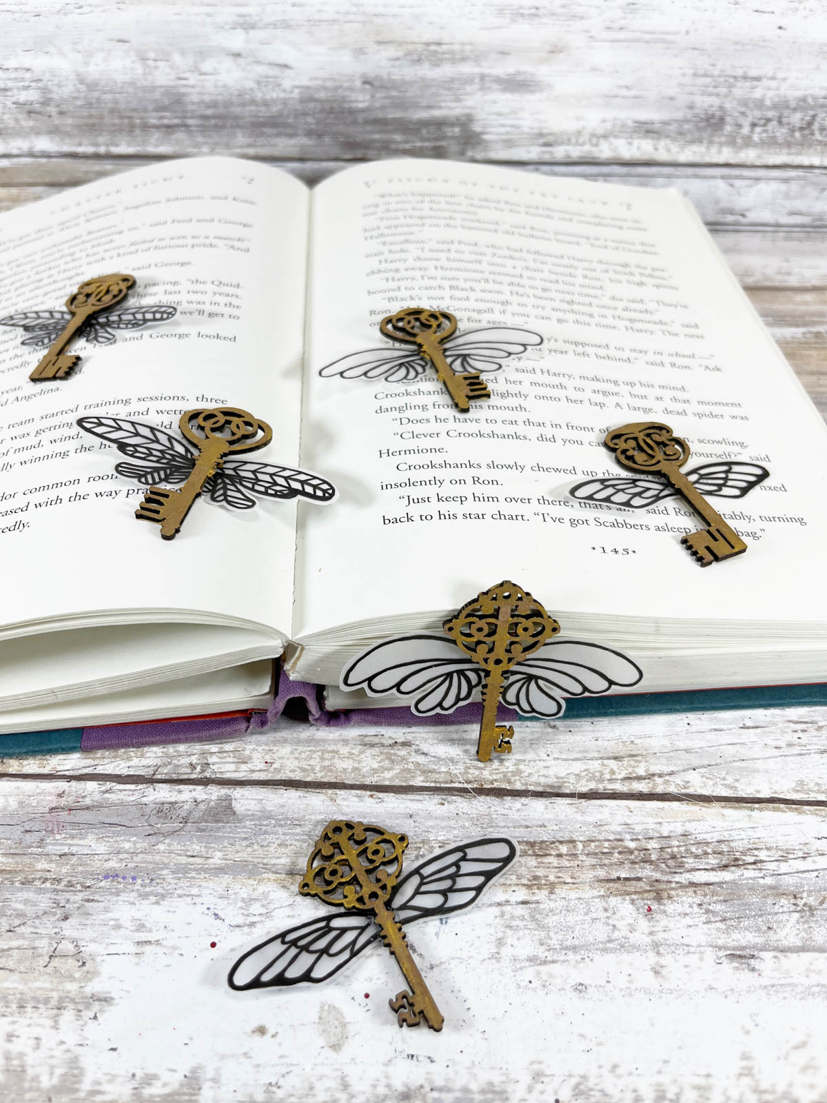 Harry Potter flying keys on a book with wooden background