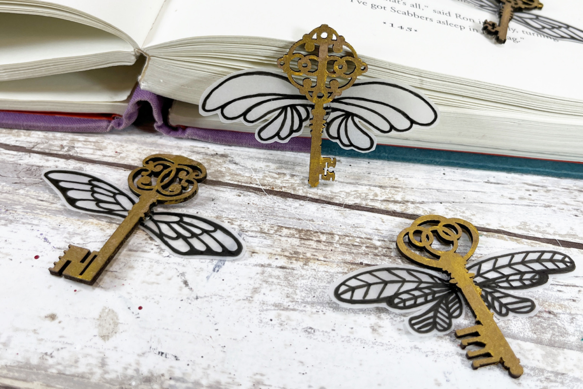 Three gold keys with wings