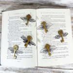 A book with a set of keys with wings on it.