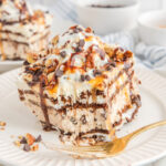 A slice of ice cream cake with chocolate and caramel.