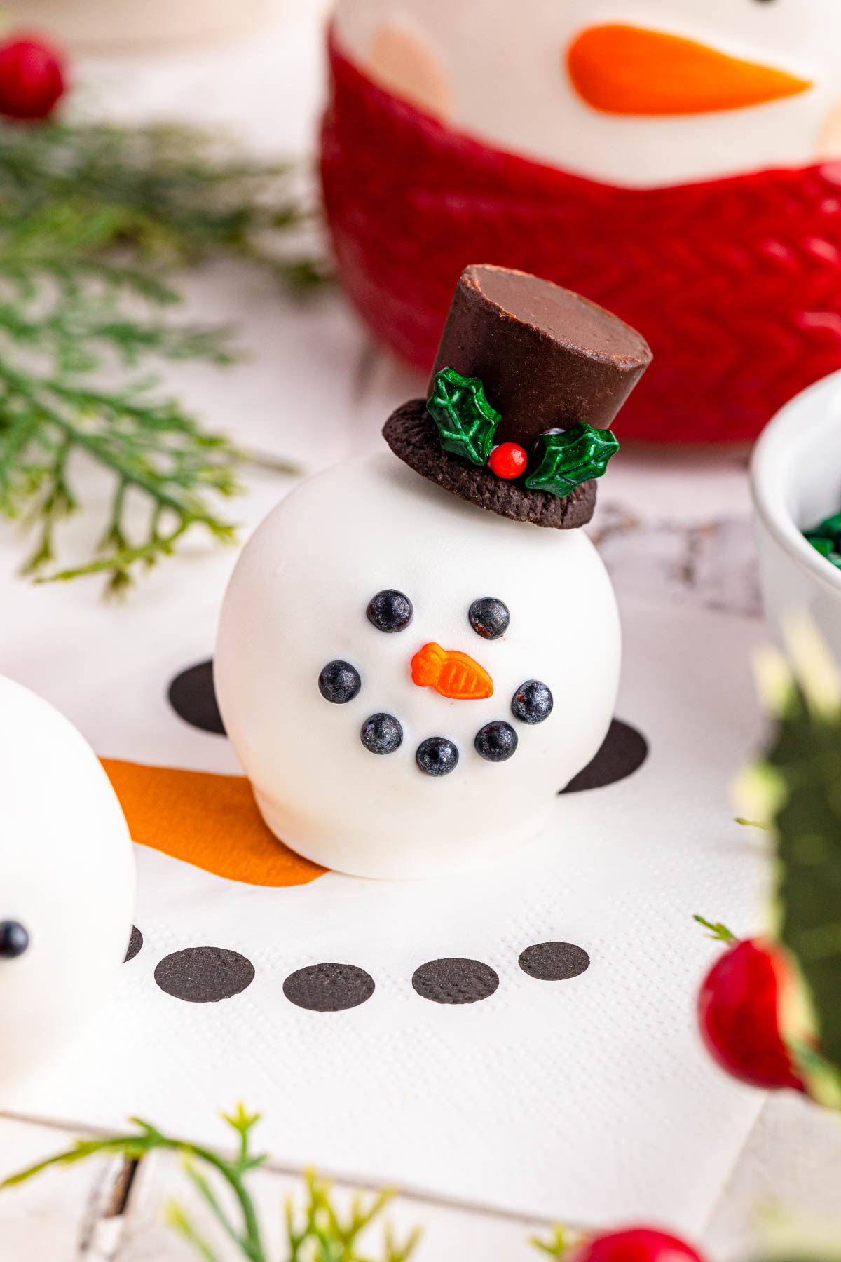 Snowman shaped chocolate balls on a table.