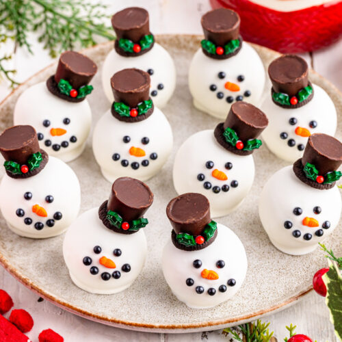 A plate of Oreo Snowman Balls on a plate.
