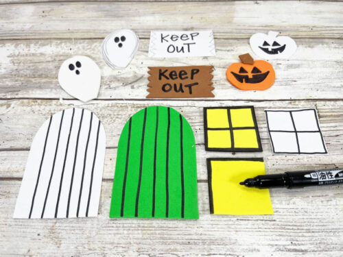 Haunted house cutouts detailed with black marker.