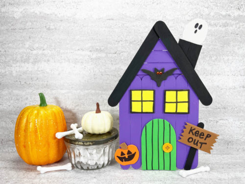 Haunted house craft next to craft pumpkins