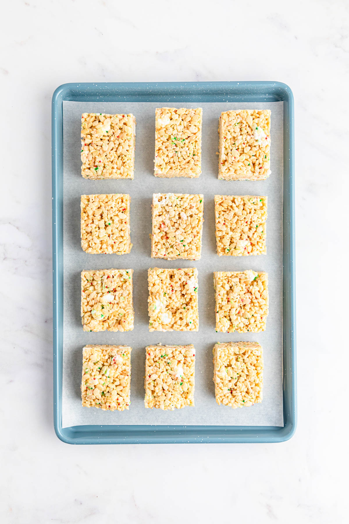 Rice krispie squares on a baking sheet.