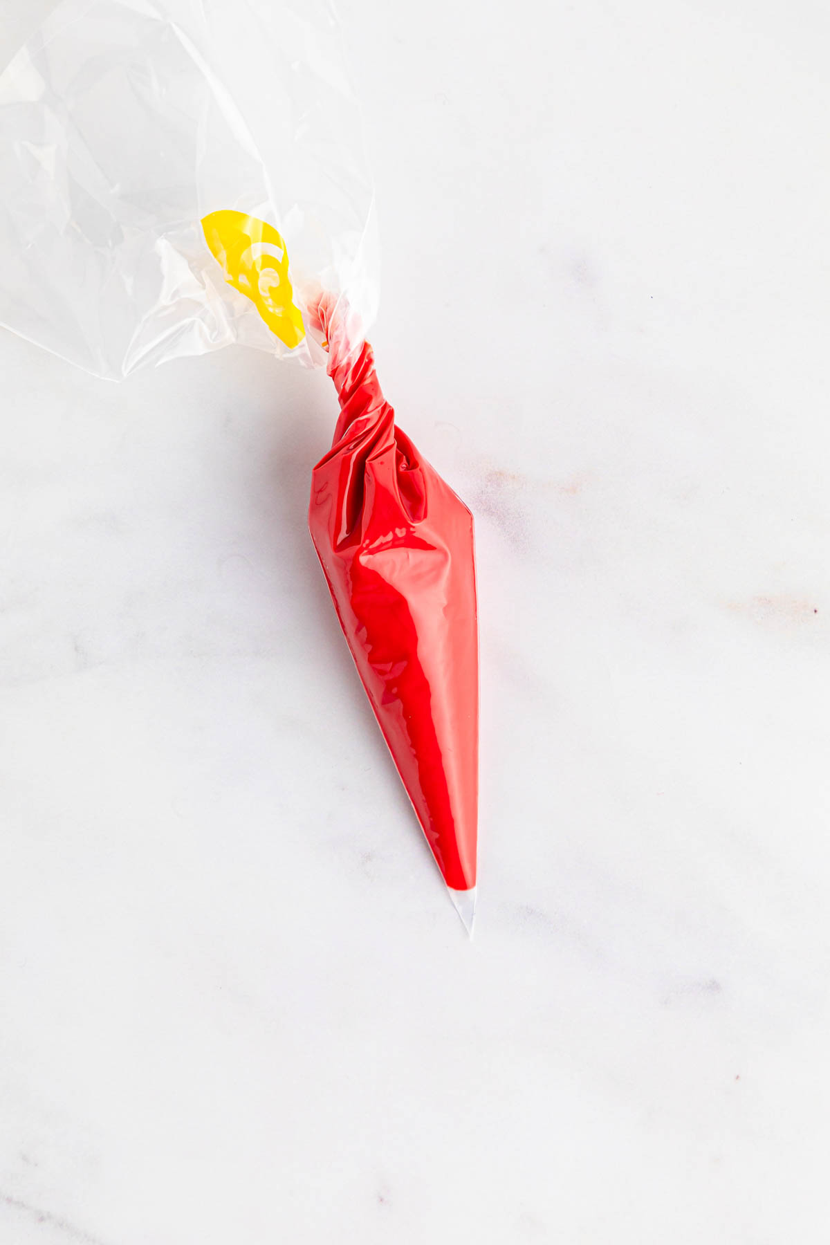 Red candy melts in a plastic bag.