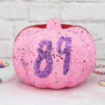 A pink pumpkin with the number 89 on it.