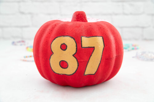 A pumpkin with the number 87 painted on it.