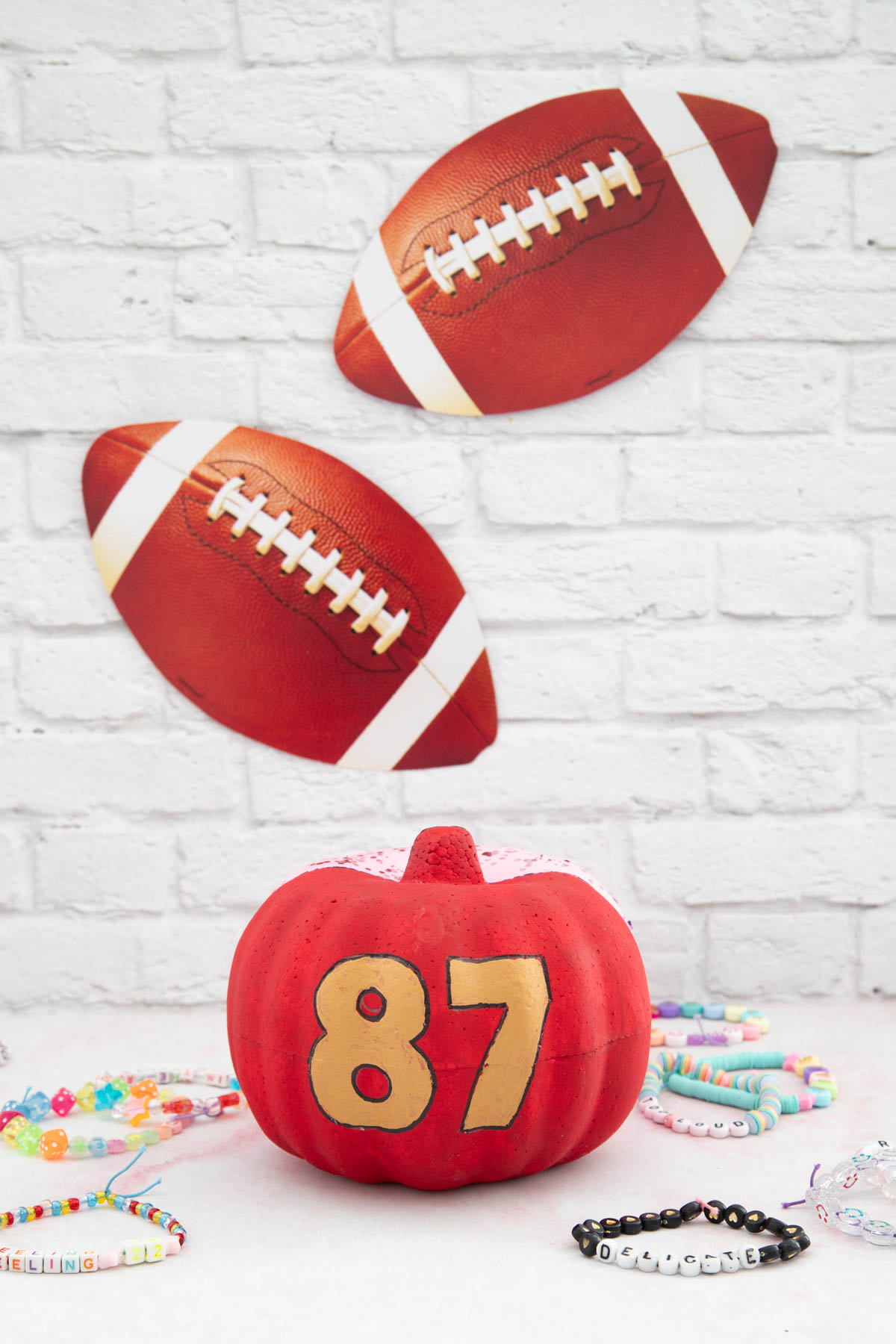 A pumpkin with the number 87 on it next to a friendship bracelets.