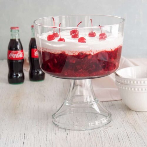Coca cola trifle in a glass bowl.