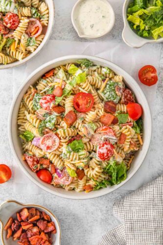 A pasta salad with bacon and tomatoes.