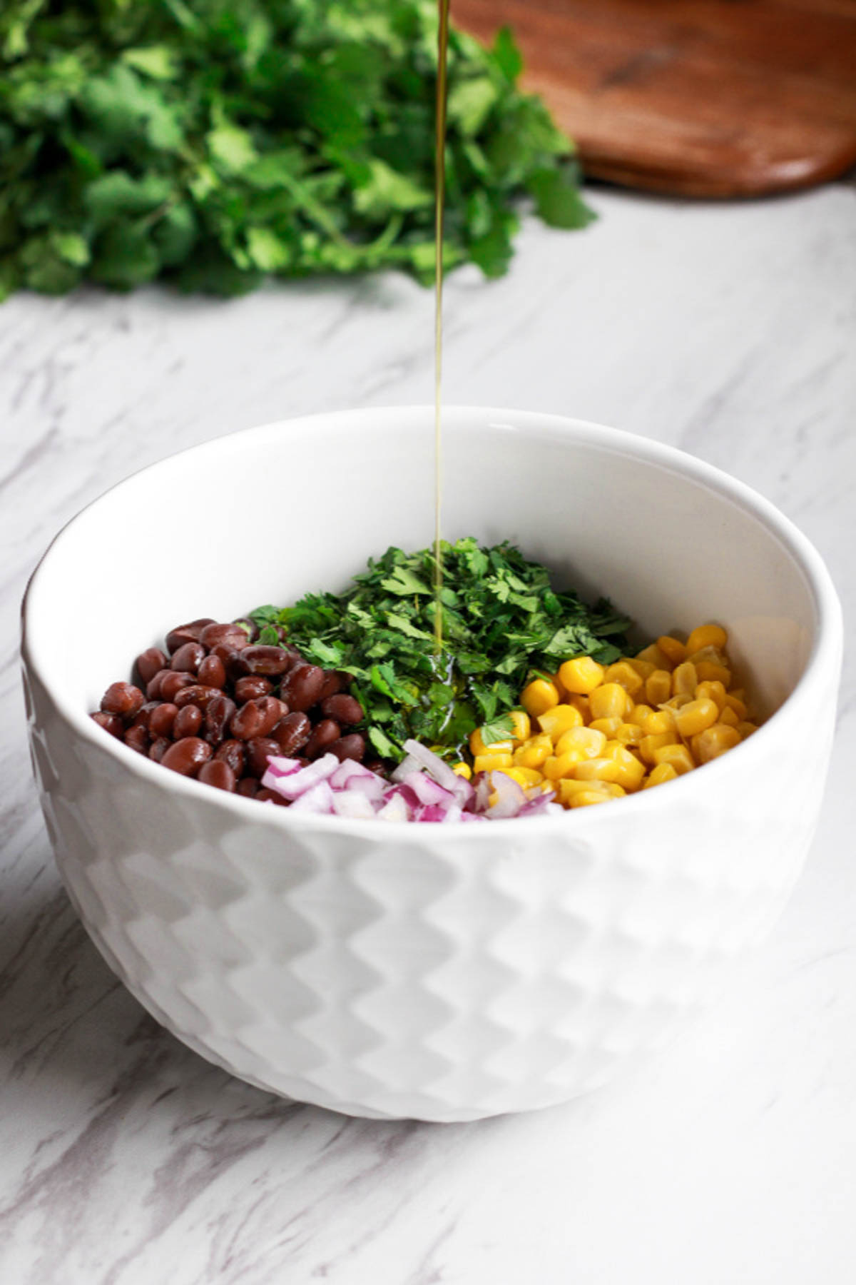 Corn and black beans in a white bowl.