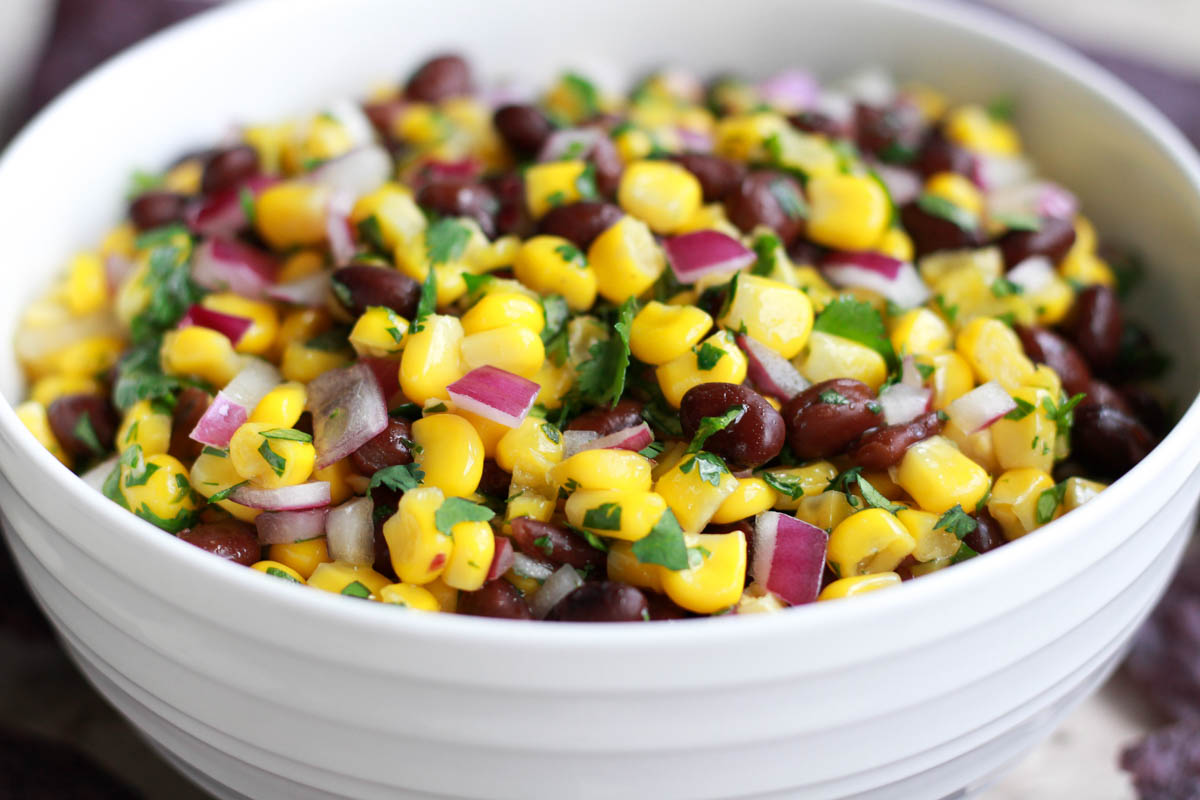 Mexican corn and black bean salad in a white bowl.