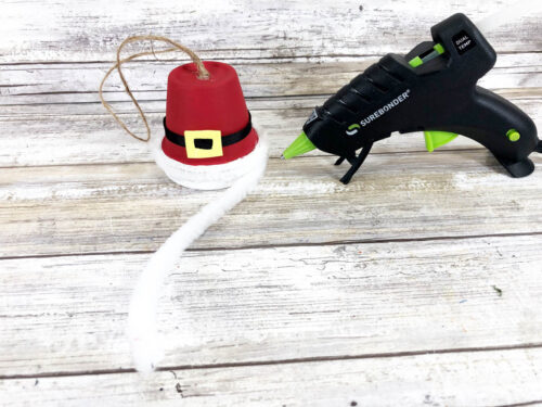 A santa hat craft with a glue gun.