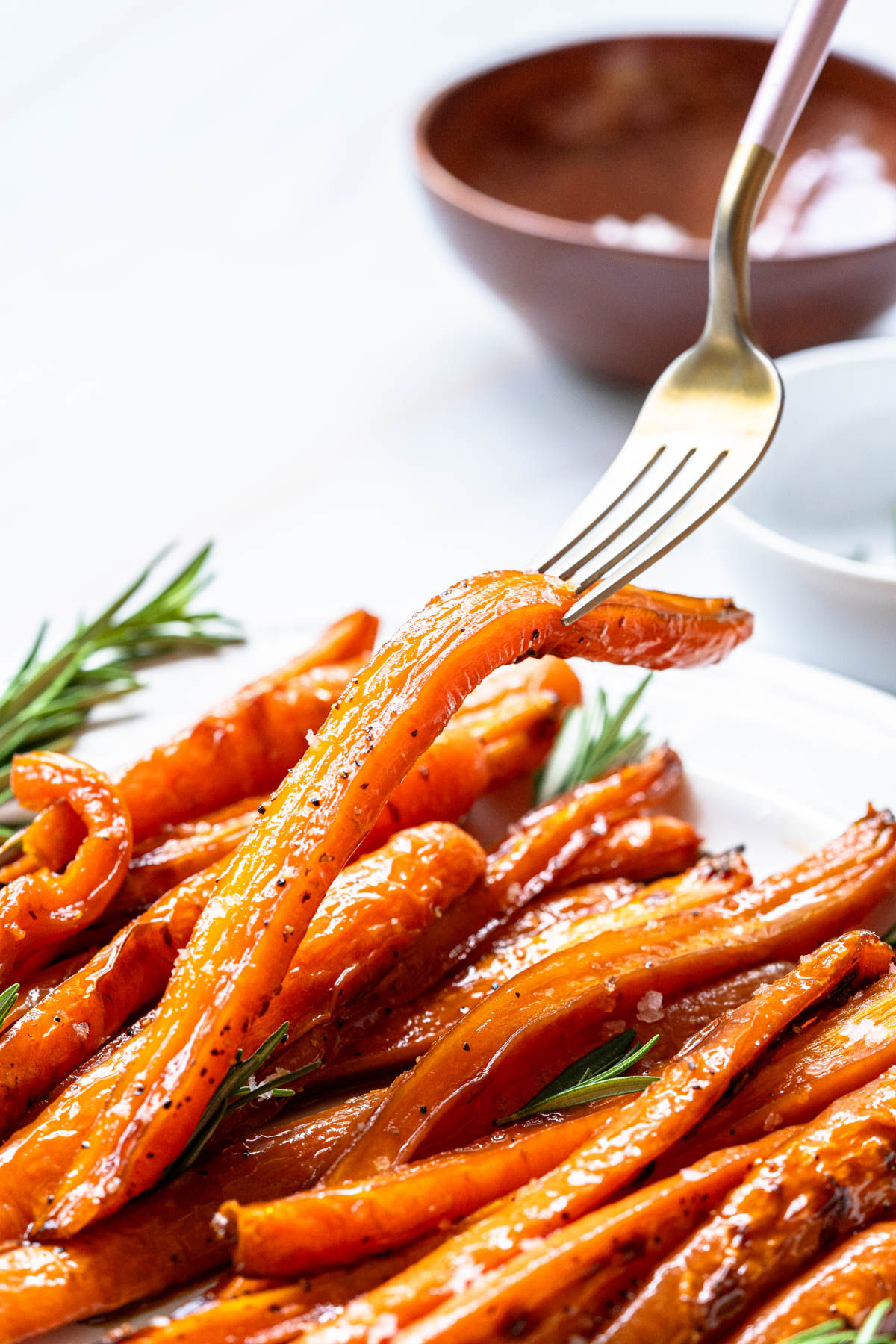 Roasted carrots on a plate with a fork.