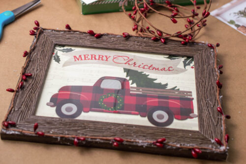 A christmas frame with a truck on it.