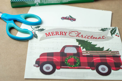 A christmas card with a truck and scissors.