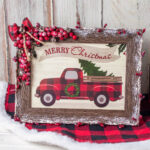A merry christmas truck in a plaid frame.