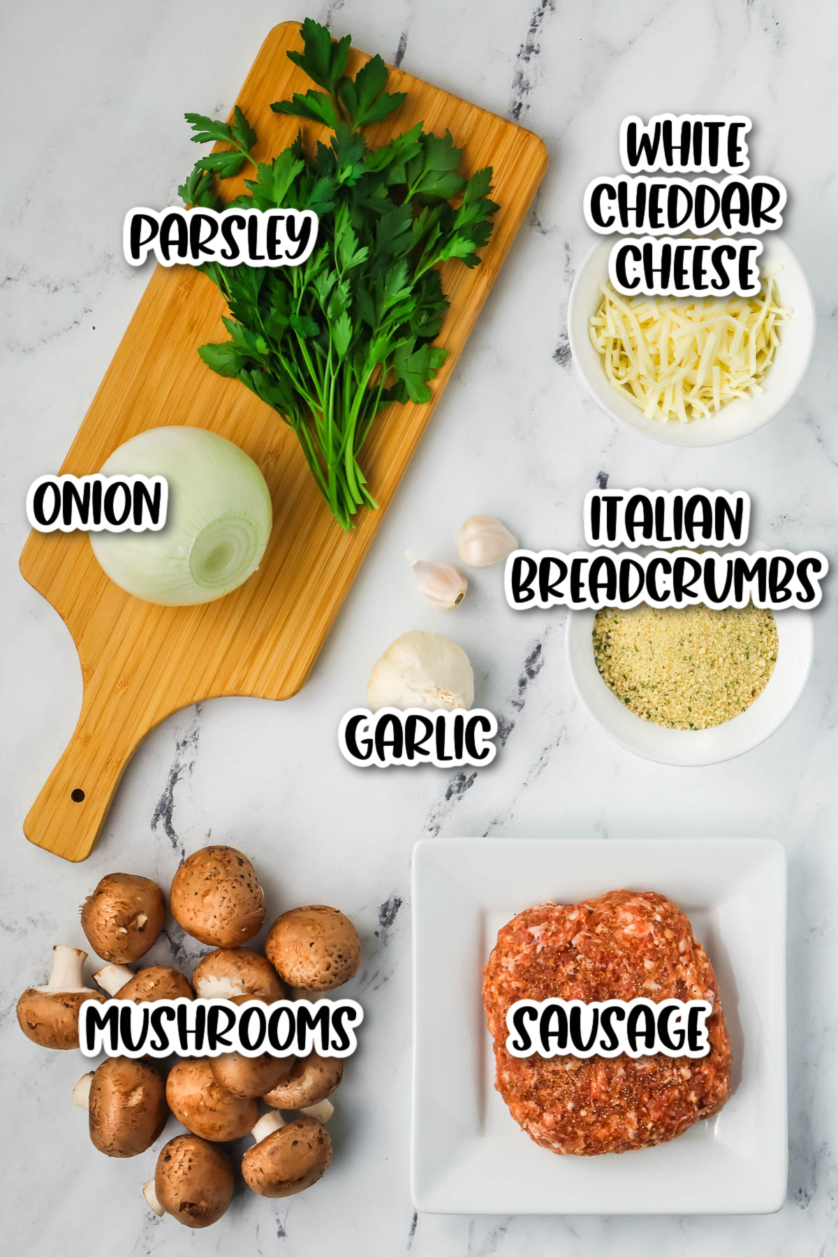 Ingredients for stuffed mushrooms on a marble cutting board.