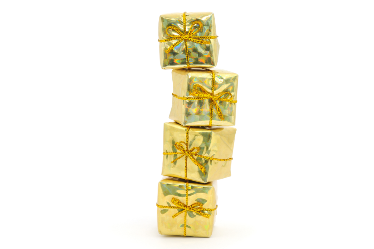 A stack of gold gift boxes on a white background.
