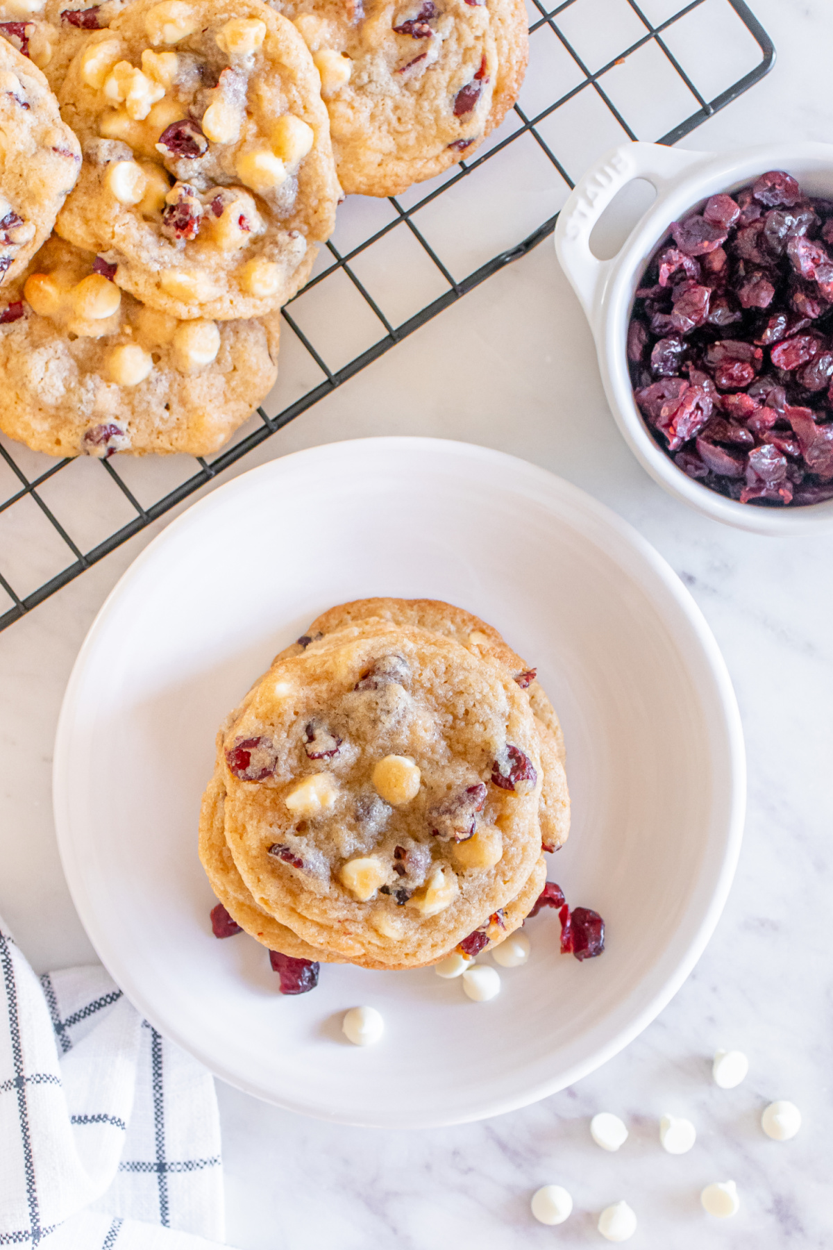 Cranberry white chocolate cookies on a plate.