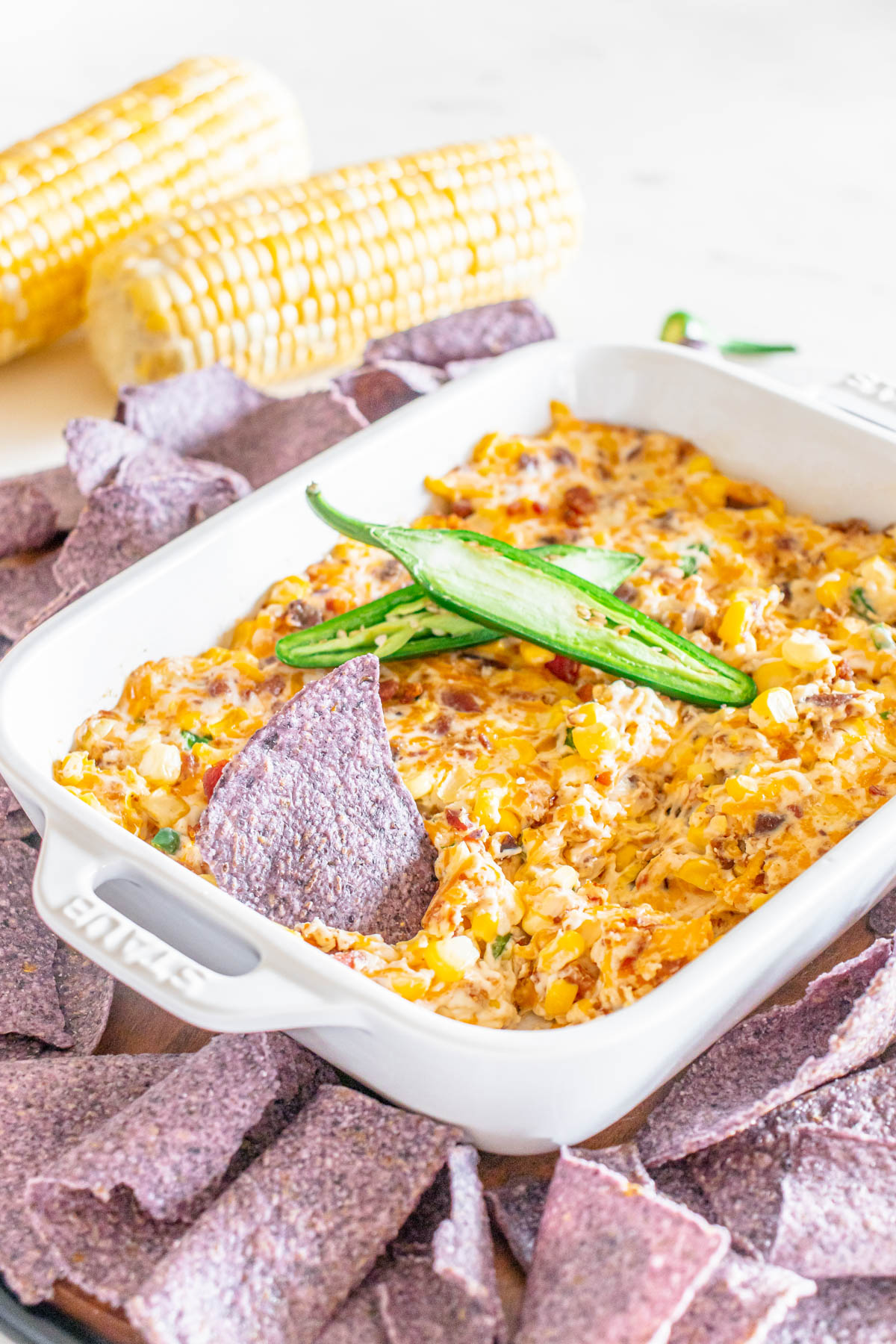 Cheesy corn dip with tortilla chips and corn on the cob.