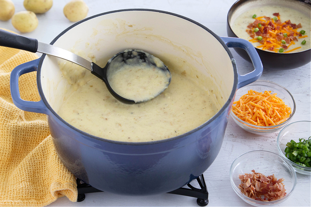 A pot filled with potatoes, cheese, and other ingredients.