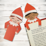 Two elf bookmarks on top of a book.