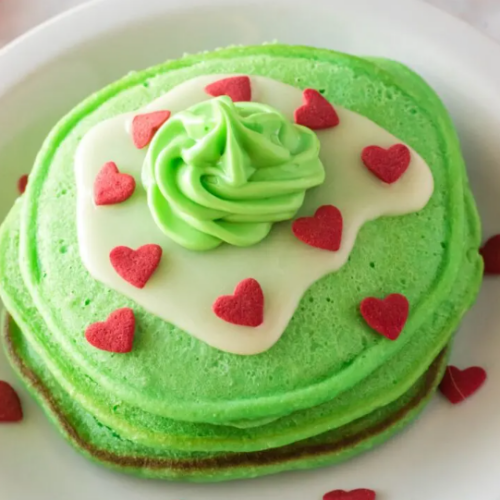Green Grinch themed pancakes with red hearts