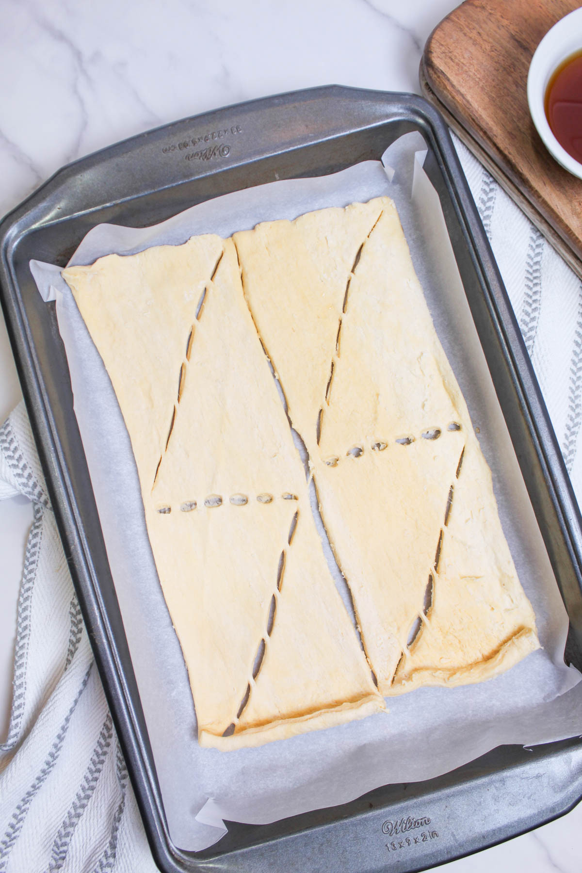 A baking sheet with a piece of pastry on it.