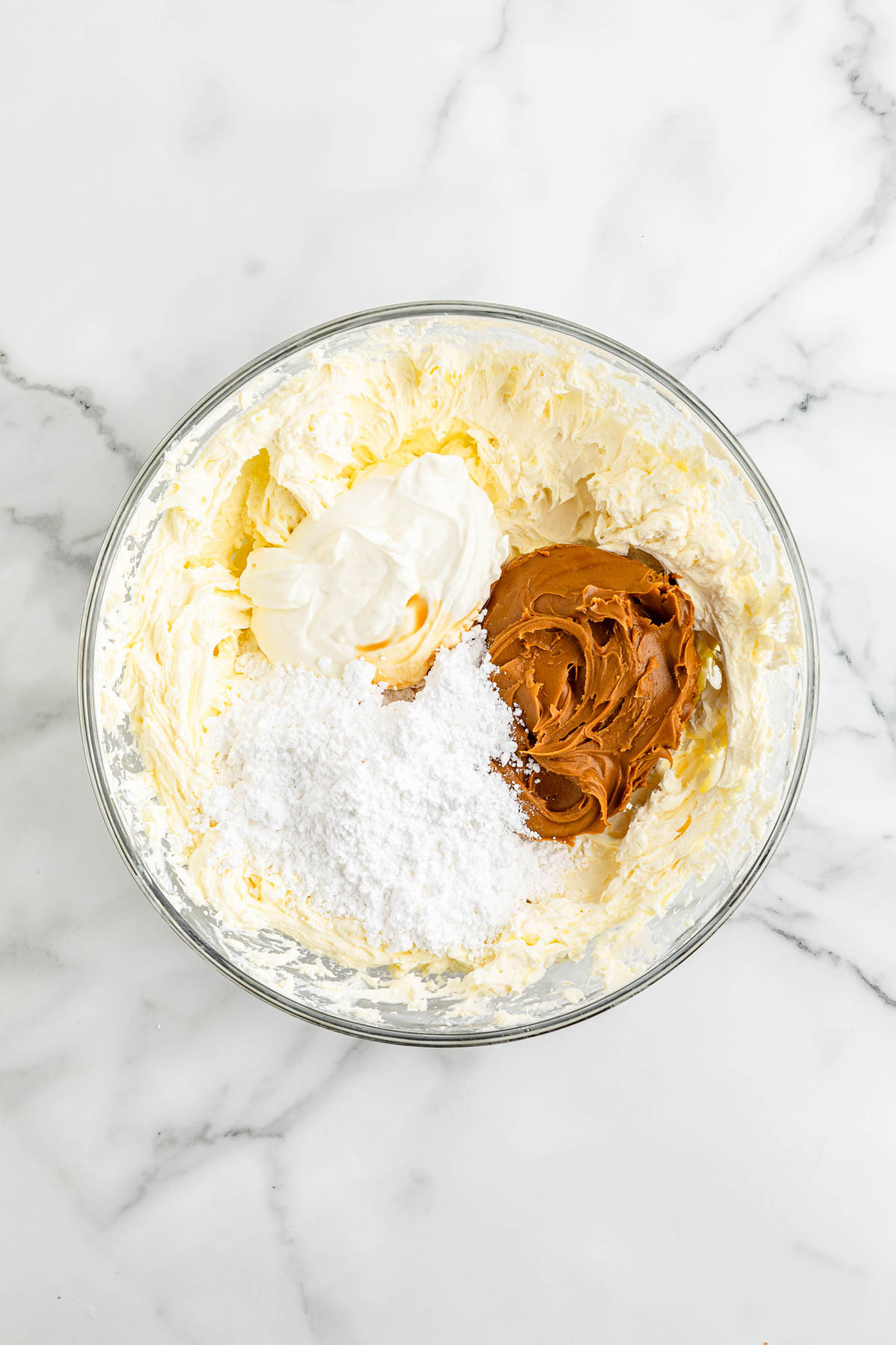 A bowl of ingredients for a Biscoff cheesecake