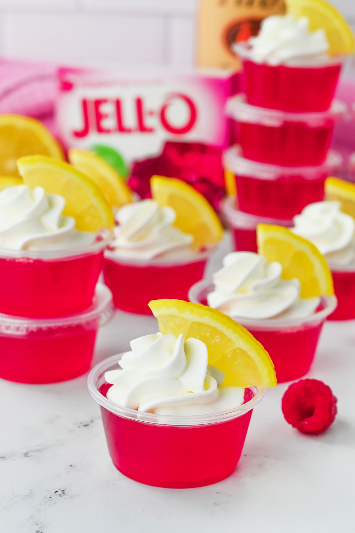 Jello cups with lemon slices and whipped cream.