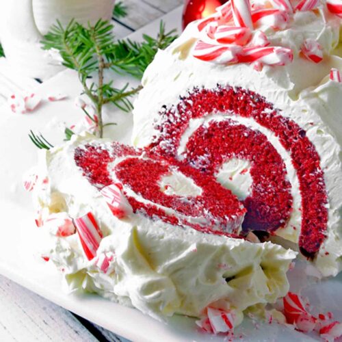 A red velvet cake with white frosting and candy canes.