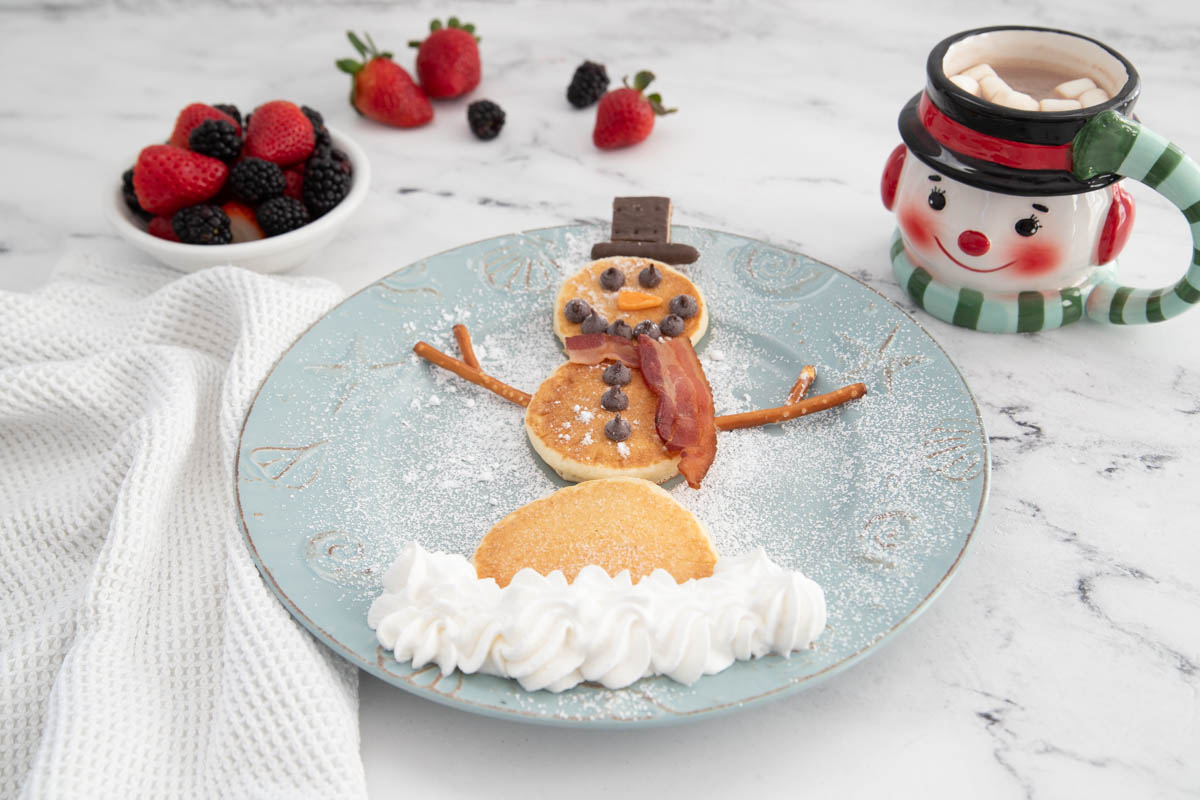 A plate of pancakes in the shape of a snowman