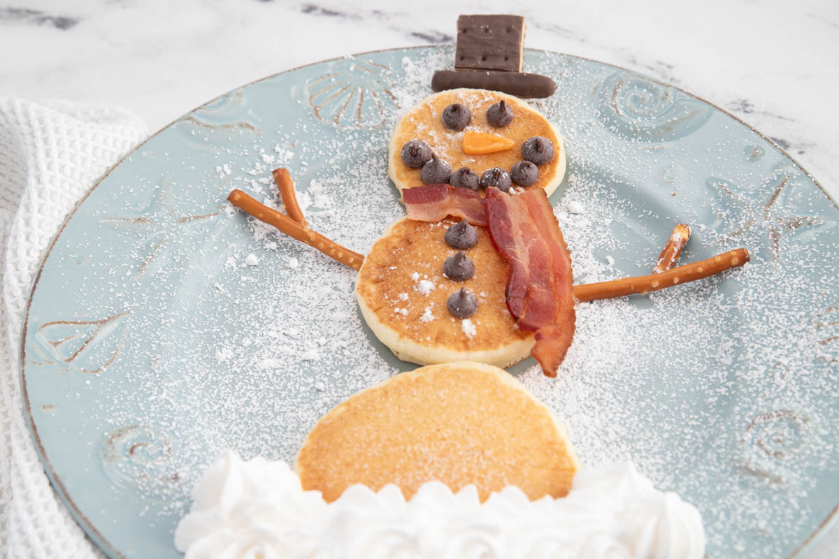 A plate of pancakes with a snowman on it.