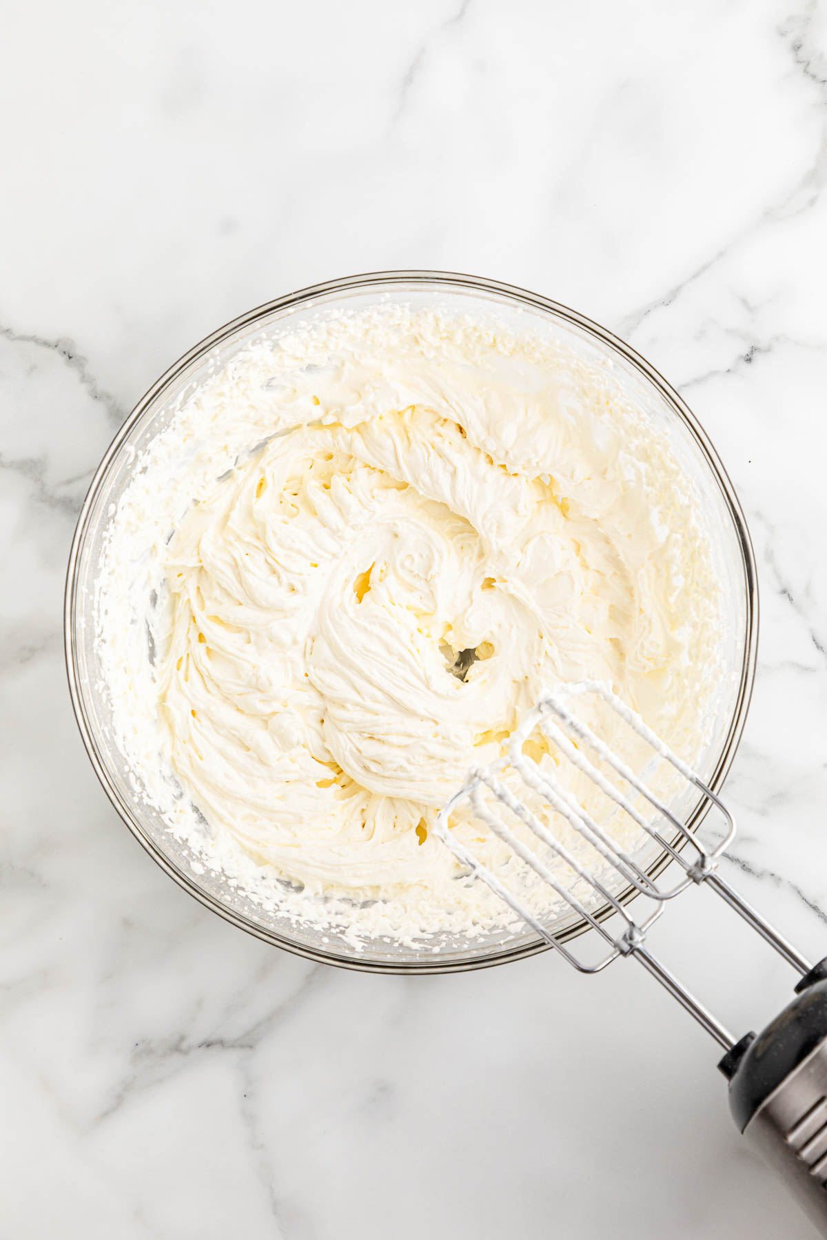 Whipping cream in a bowl with a mixer