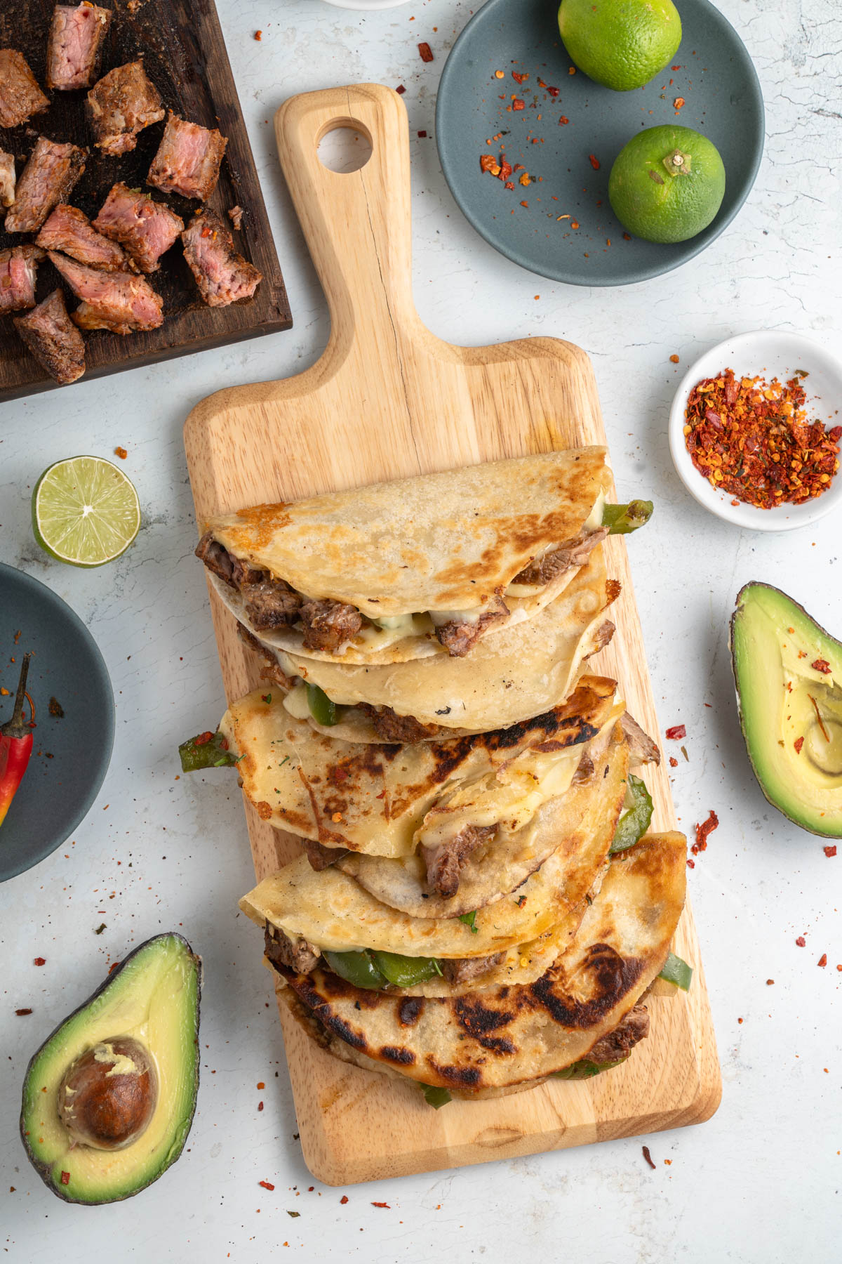 A stack of quesadillas on a cutting board.