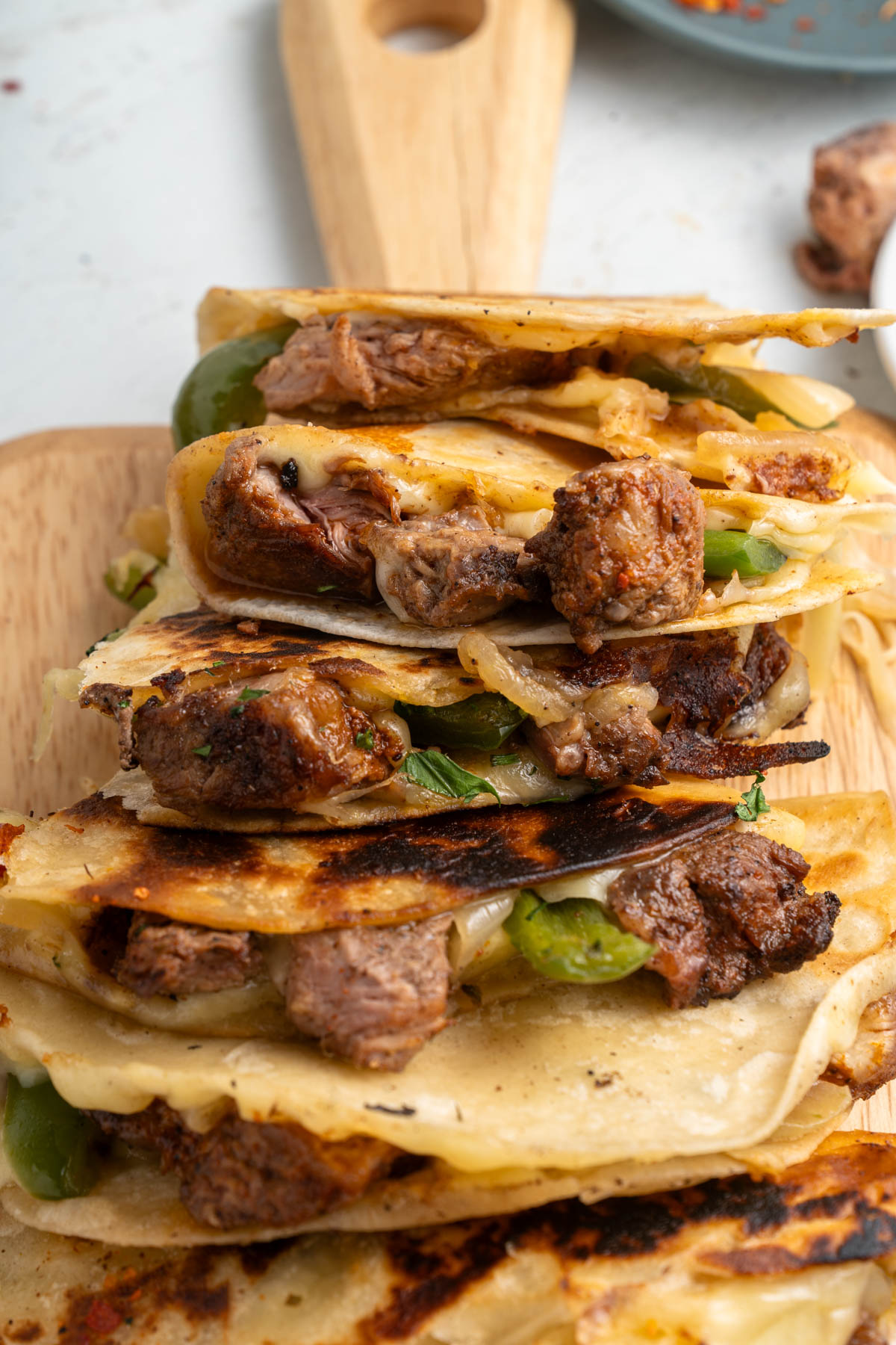 A stack of quesadillas on a cutting board.