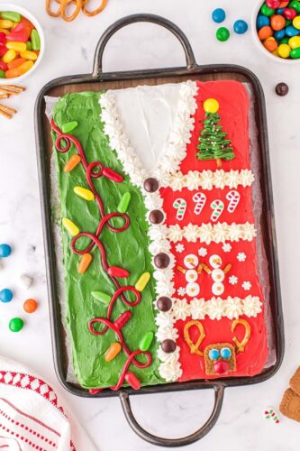 A christmas cake decorated with candy and candy canes.