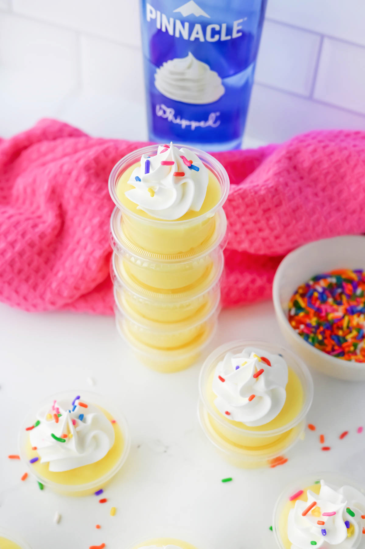 Birthday cake shots with whipped cream and sprinkles.