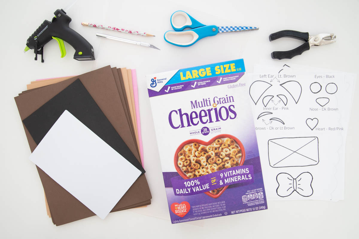 A box of cereal, scissors, glue, and a box of cereal.