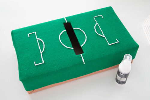 A green tissue with a soccer field painted on it.