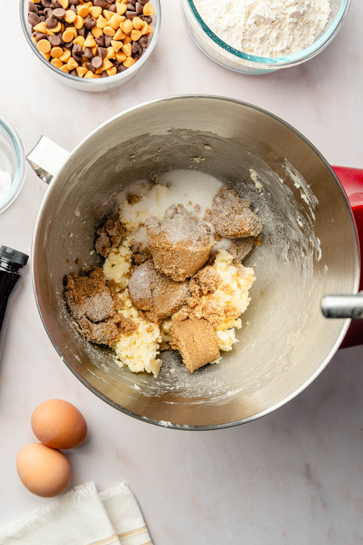 A mixing bowl filled with ingredients for a cookie recipe.