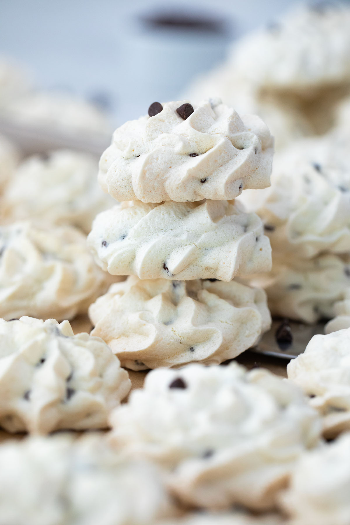 A stack of meringue cookies with chocolate chips.
