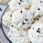 Chocolate chip meringue cookies on a plate.