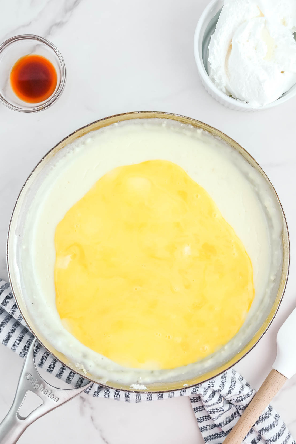 A pan with a eggs and coconut cream pie ingredients