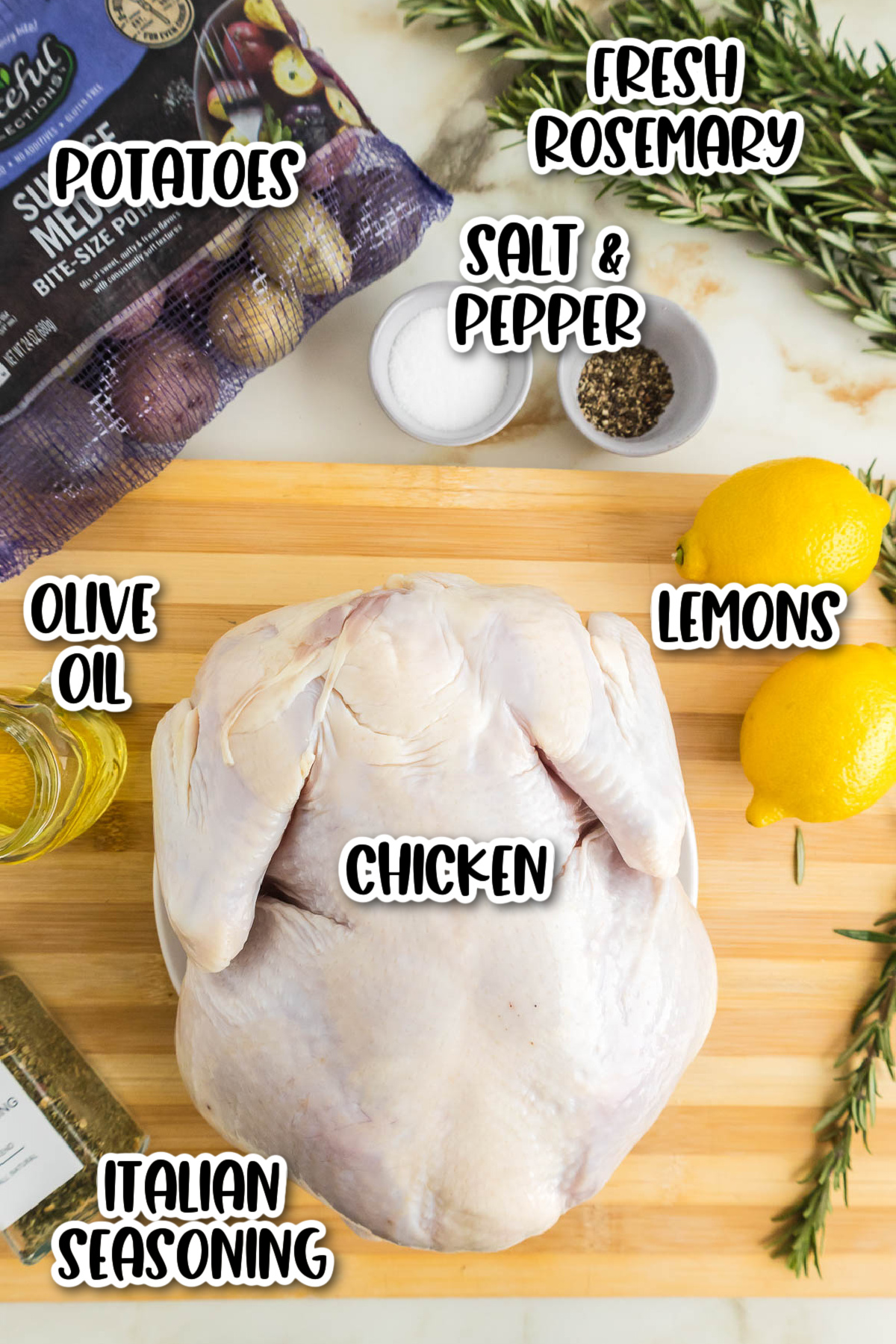 A cutting board with ingredients for lemon rosemary chicken.