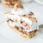 A slice of Cool Whip Cookie Pie with whipped cream on top.
